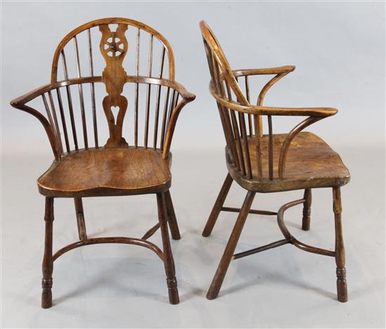 A set of four early 19th century yew, ash and elm wheelback Windsor armchairs,
